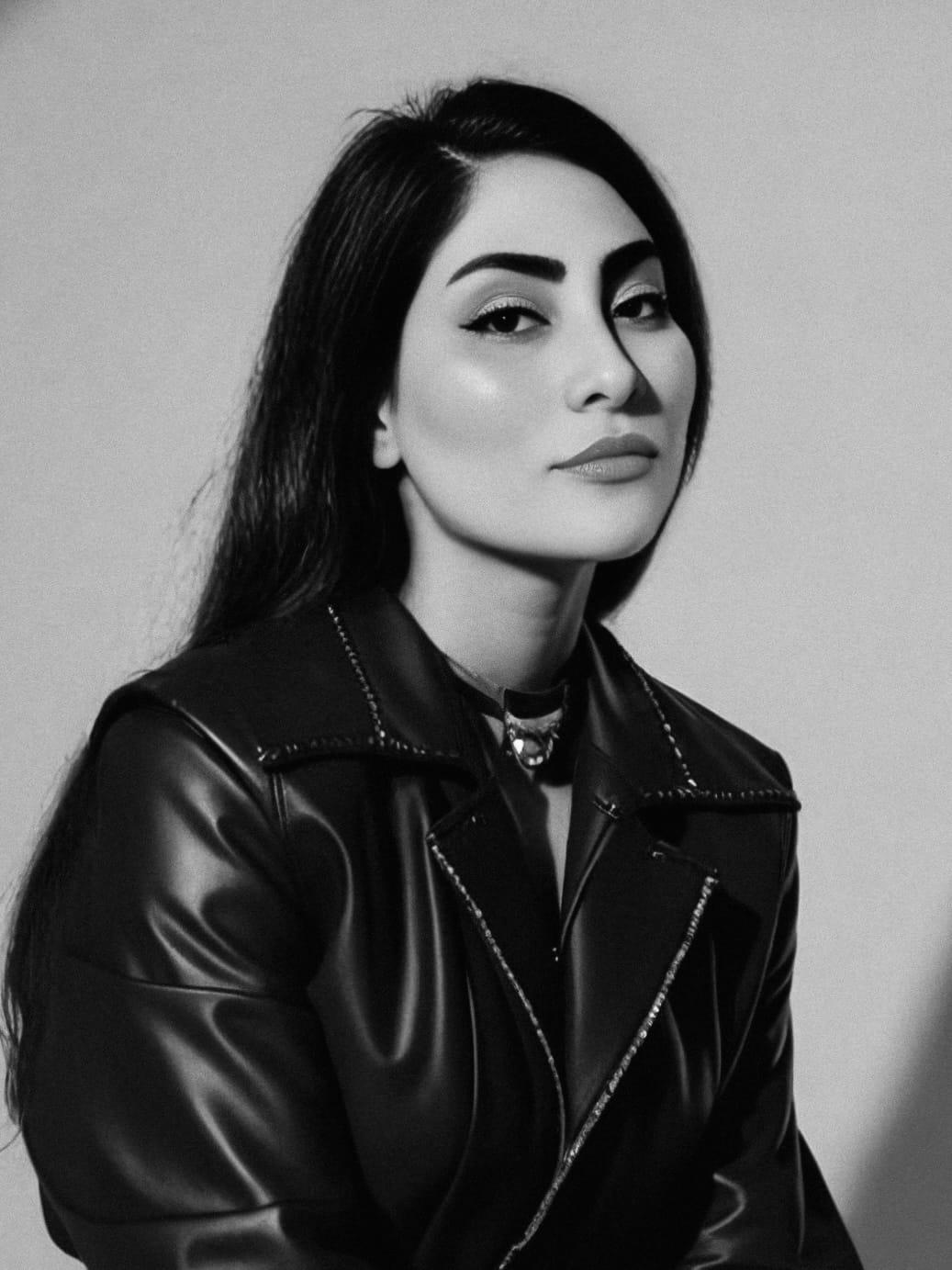 Studio portrait of 5OGOL in a leather jacket, black and white